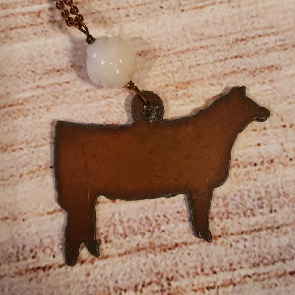 Metal cow necklace with white bead